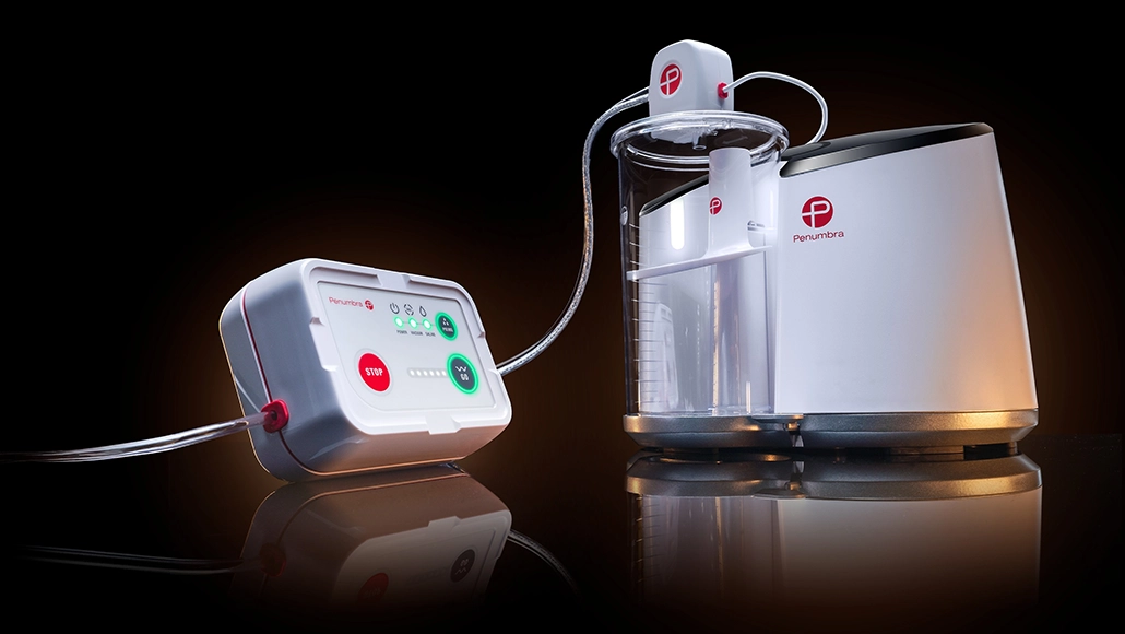 Penumbra blood-purification system with a control unit on the left connected by tubing to a clear cylindrical pump on the right.